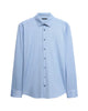 A light blue long-sleeve button-down shirt with a classic collar and button-down front, displayed on a neutral light gray background.